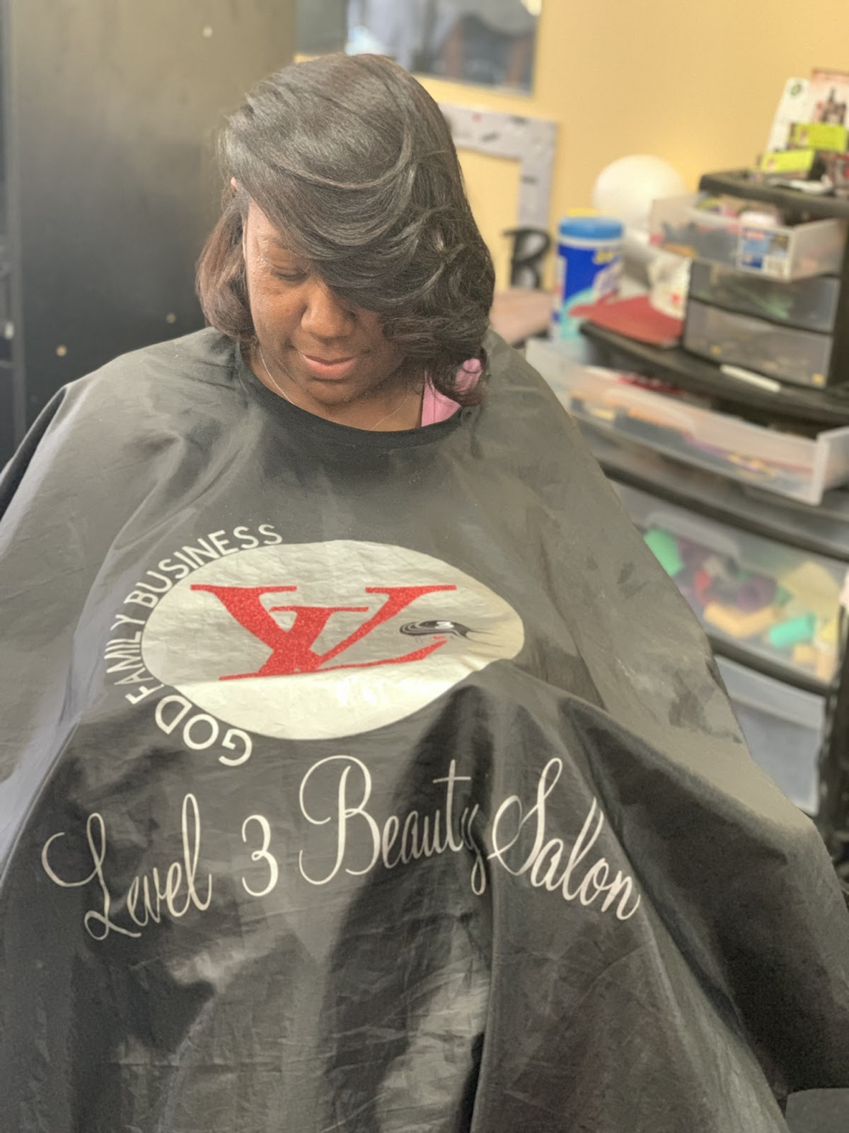 Client in a Level 3 Salon cape after a sleek styled blowout